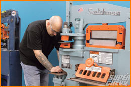 After transferring the template from the illustration board, Pete Bonafide uses a massive Scotchman iron worker to nibble the part to its final shape roll cage